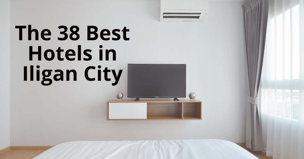 Minimalist hotel room with TV, AC, white bedding, and large window. Explore on the Iligan website for top hotels.