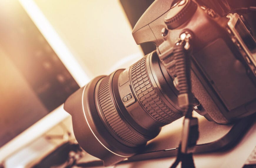 close up of a dslr camera with a large lens hood on a desk, capturing the essence of iligan photographers.