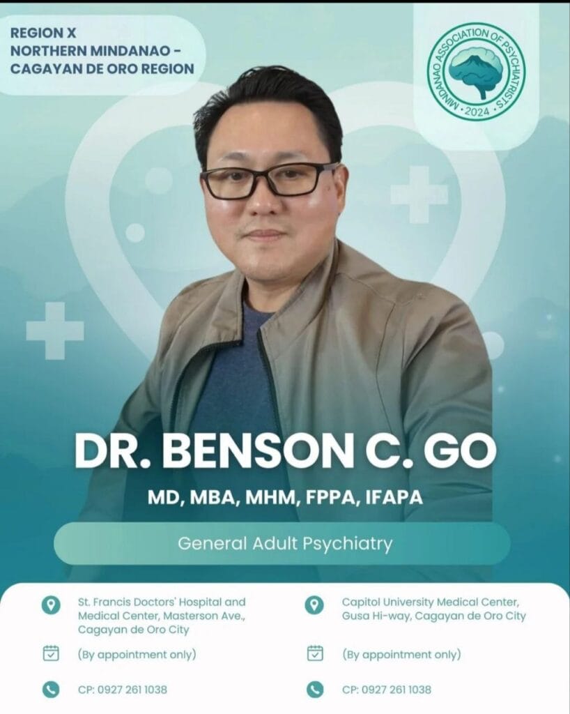 a man wearing glasses and a jacket.