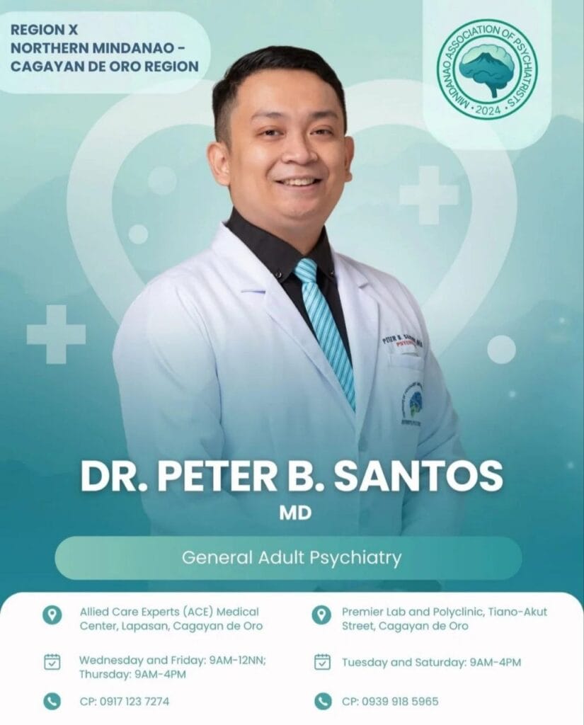 smiling male doctor in a white coat poses beside his psychiatry clinic info on a blue green background.