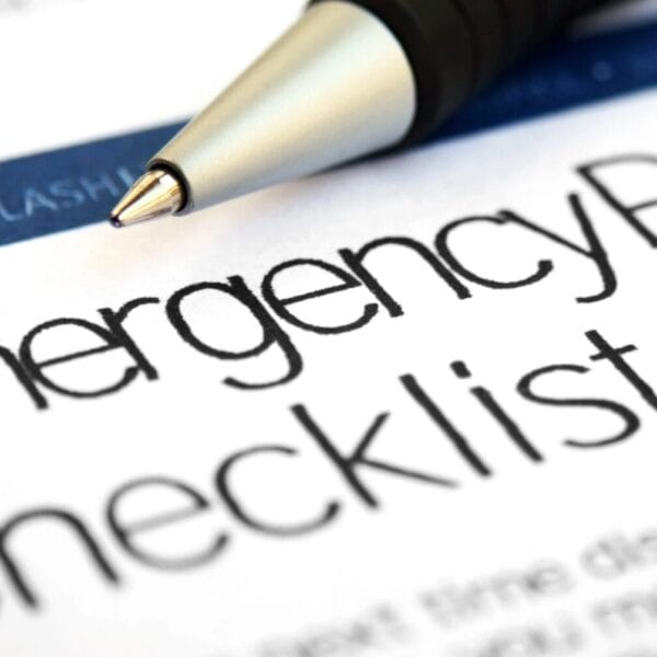 a pen rests on paper titled emergency preparedness checklist from iligan city disaster risk reduction.