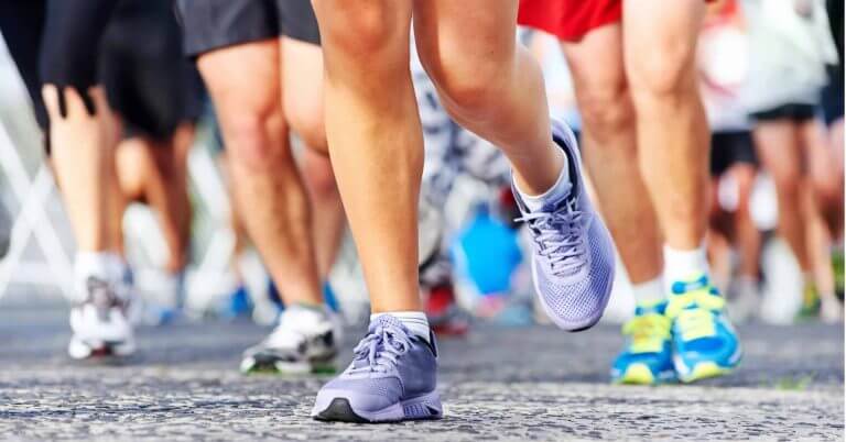 close up of runners’ legs and colorful shoes during the kasadya half marathon in iligan city.