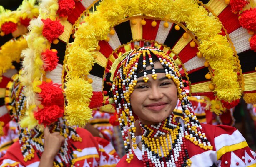 A smiling person in colorful attire at Brgy. Buru-un during the Iligan Street Dancing Festival.