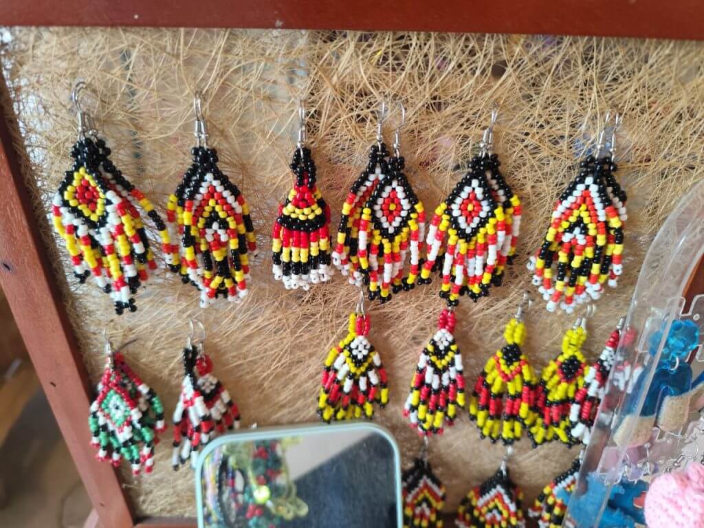 handmade beaded earrings in red, yellow, black, and white&mdash;perfect iligan arts souvenirs for crafts lovers.