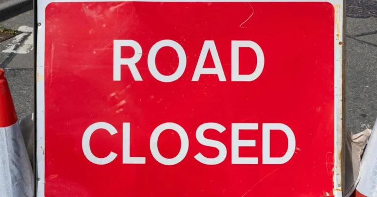 a red road closed sign marks street closures in iligan during the vibrant diyandi festival.