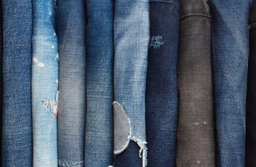 folded blue and black jeans, some distressed, neatly arranged—perfect for a thrift hunt iligan adventure.