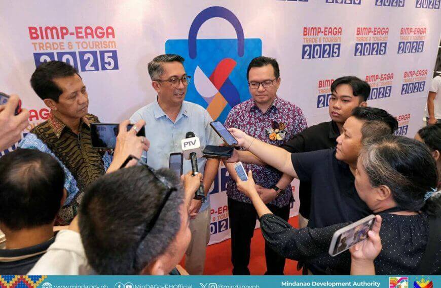 a man speaks to reporters at a bimp eaga 2025 event, surrounded by media and microphones.