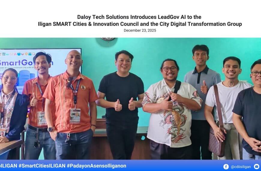 eight people stand smiling indoors, some giving thumbs up, in front of a smartgov ai presentation screen.
