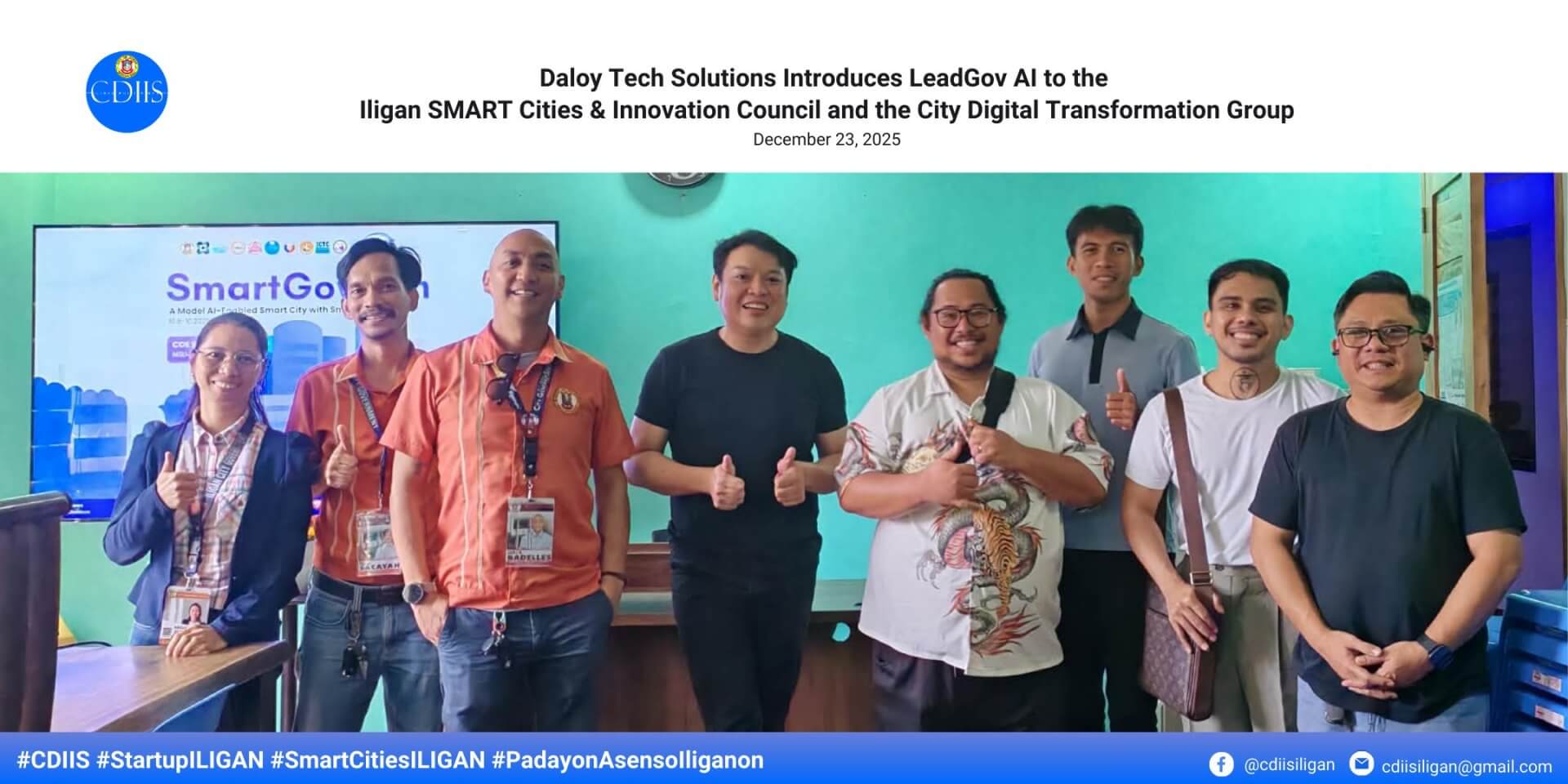 eight people stand smiling indoors, some giving thumbs up, in front of a smartgov ai presentation screen.