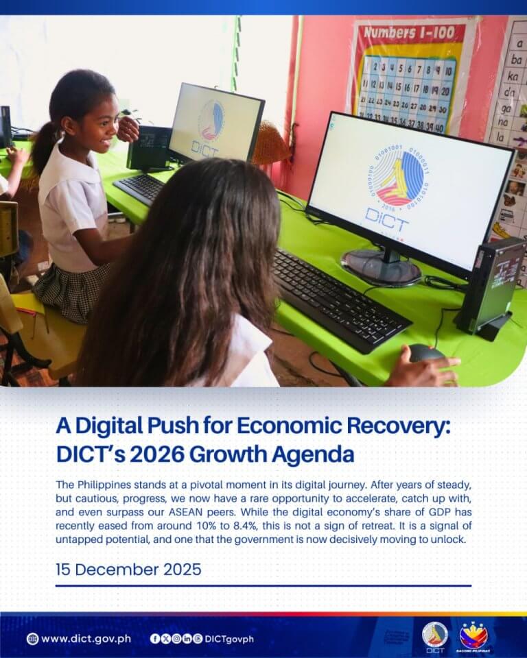 two girls in school uniforms use desktop computers in a classroom with the dict logo on the screens.