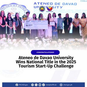 a group on stage with a trophy and large check, celebrating the 2025 tourism start up challenge at ateneo de davao university.