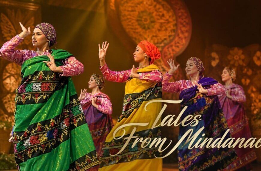five women in mindanao attire perform a dance on stage with adlaw sa iligan and tales from mindanao overlay.