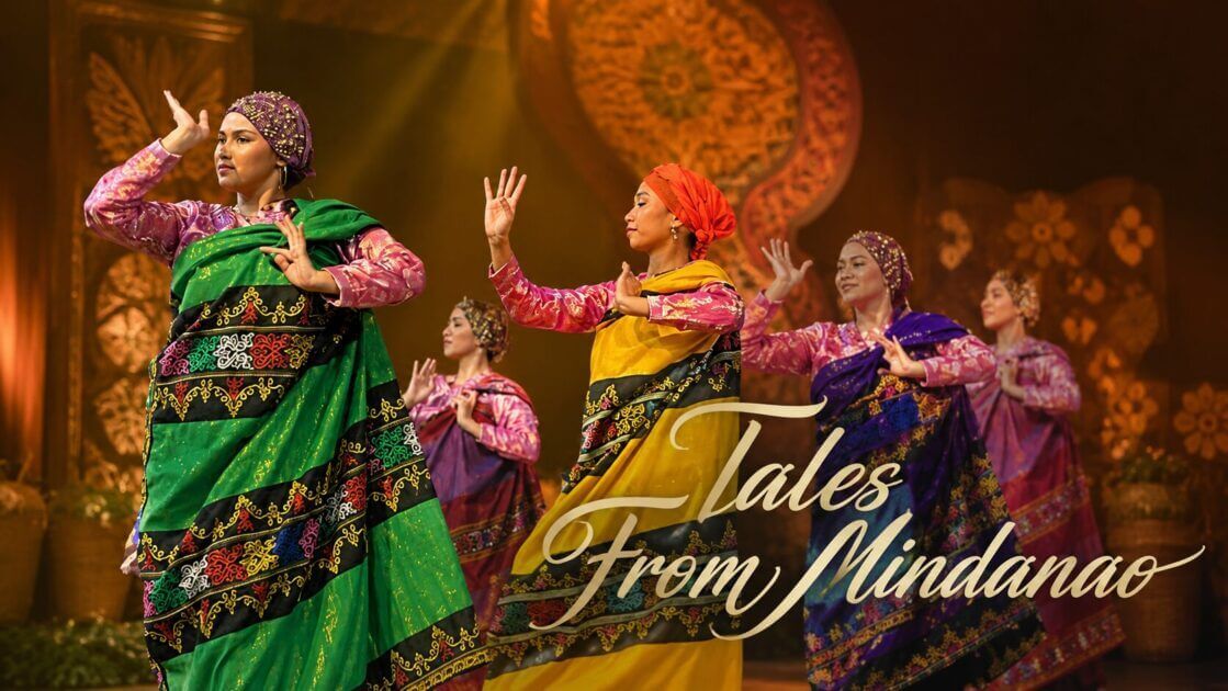 five women in mindanao attire perform a dance on stage with adlaw sa iligan and tales from mindanao overlay.